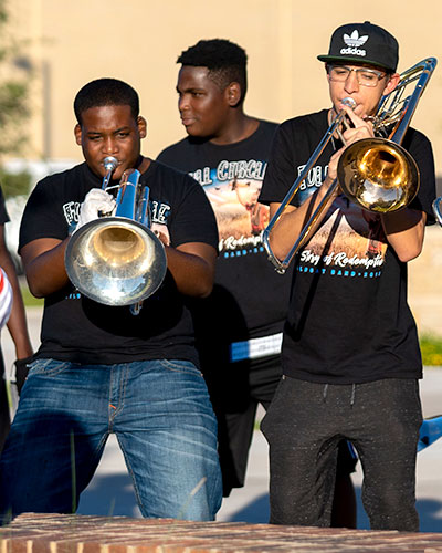 Brass musicians playing side by side