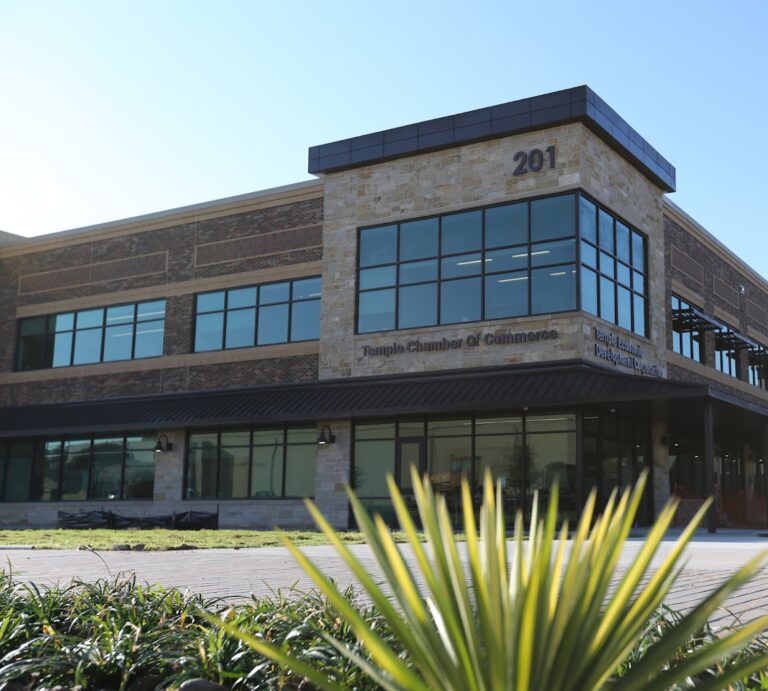 A commercial building against a sunny sky