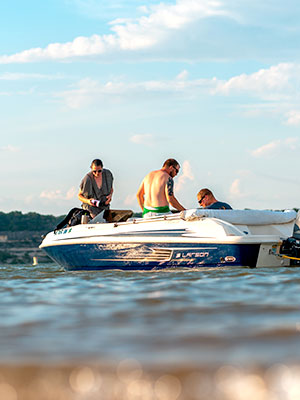 A group of people sitting on a boat on a lake