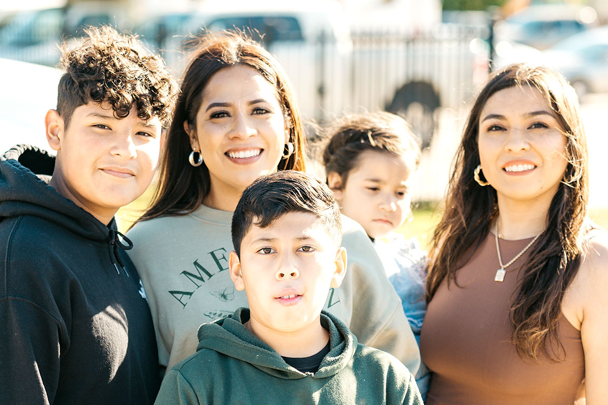 Family of five looking at camera smiling